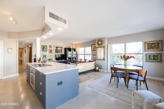 kitchen with black electric cooktop, concrete floors, baseboards, open floor plan, and recessed lighting
