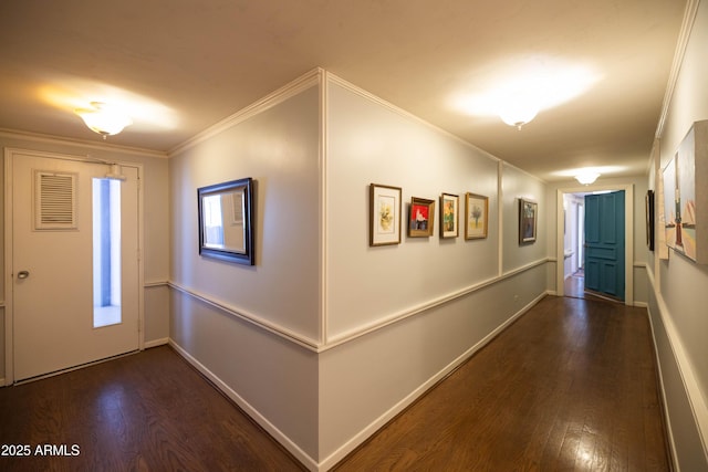 foyer entrance with wood finished floors, crown molding, and baseboards