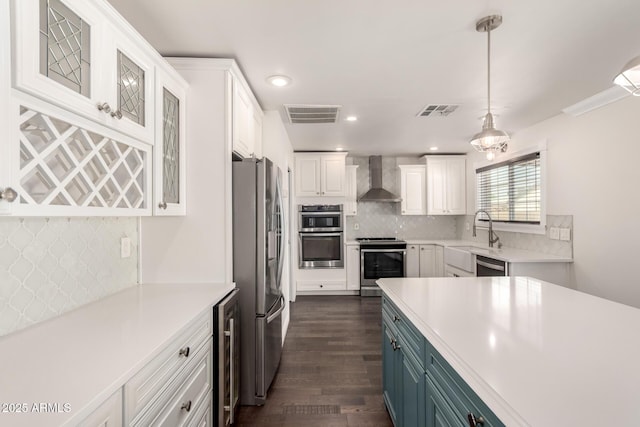 12241 N 49th Ave, Glendale, AZ 85304 - kitchen with appliances with stainless steel finishes, wall chimney range hood, wine cooler, white cabinetry, and a sink