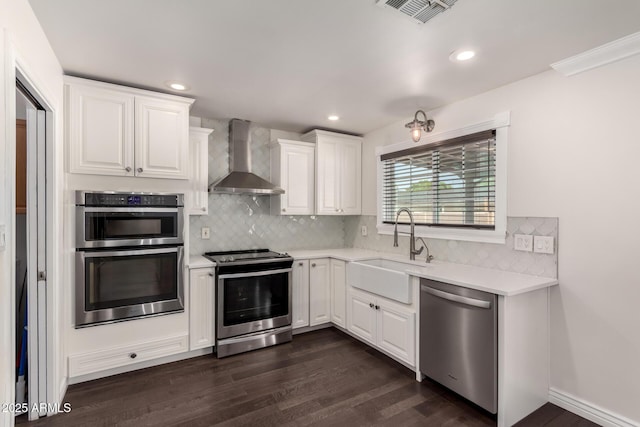 12241 N 49th Ave, Glendale, AZ 85304 - kitchen with appliances with stainless steel finishes, wall chimney exhaust hood, a sink, light countertops, and decorative backsplash