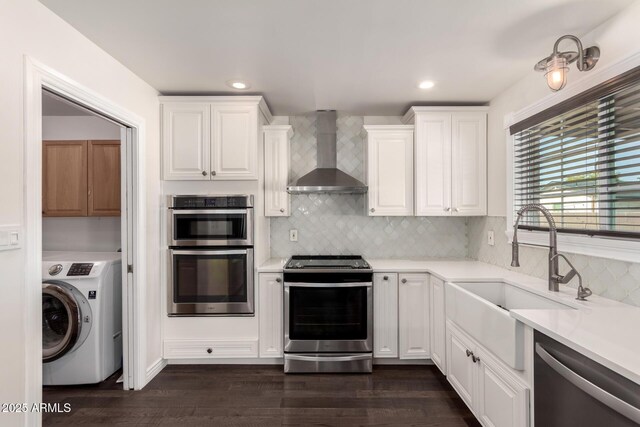 12241 N 49th Ave, Glendale, AZ 85304 - kitchen with washer / dryer, stainless steel appliances, wall chimney range hood, a sink, and light countertops