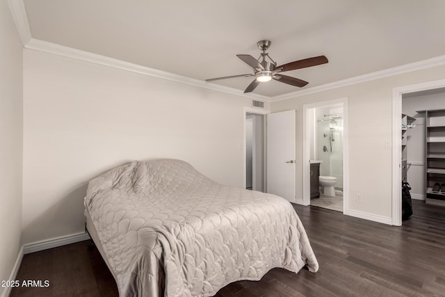12241 N 49th Ave, Glendale, AZ 85304 - bedroom with a walk in closet, baseboards, crown molding, dark wood-style flooring, and ensuite bathroom