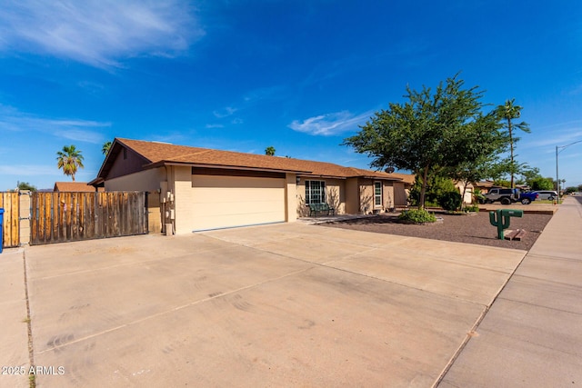 12241 N 49th Ave, Glendale, AZ 85304 - ranch-style house with stucco siding, a garage, and driveway