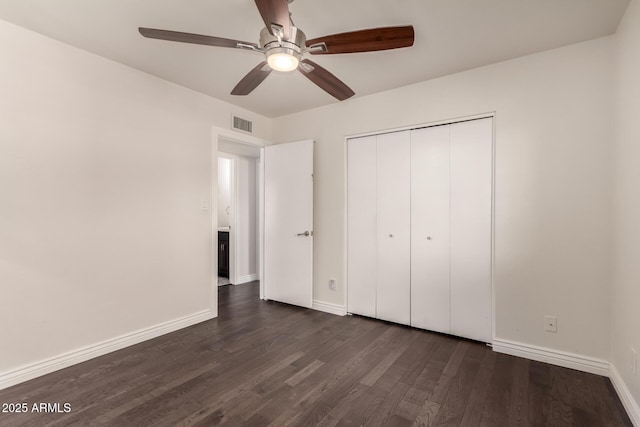 12241 N 49th Ave, Glendale, AZ 85304 - unfurnished bedroom with baseboards, dark wood-style flooring, a closet, and a ceiling fan