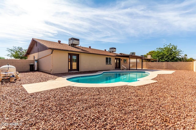 12241 N 49th Ave, Glendale, AZ 85304 - view of swimming pool featuring a fenced backyard, a patio, and cooling unit