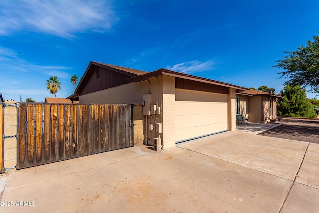 12241 N 49th Ave, Glendale, AZ 85304 - view of front facade featuring a garage, driveway, and a gate