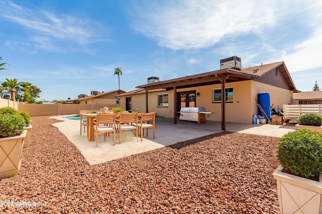 12241 N 49th Ave, Glendale, AZ 85304 - back of property featuring a fenced backyard, a patio, stucco siding, and a chimney