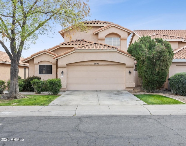 mediterranean / spanish home featuring stucco siding, concrete driveway, an attached garage, and a tile roof