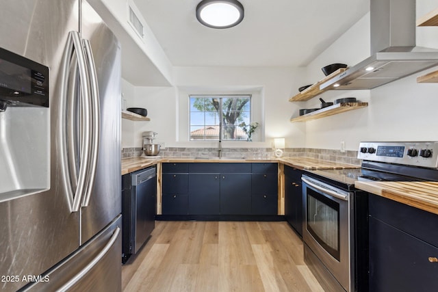 7931 W Shaw Butte Dr, Peoria, AZ 85345 - kitchen featuring light wood-type flooring, open shelves, a sink, appliances with stainless steel finishes, and wall chimney range hood