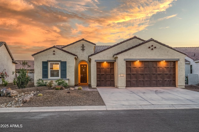 mediterranean / spanish home featuring a garage