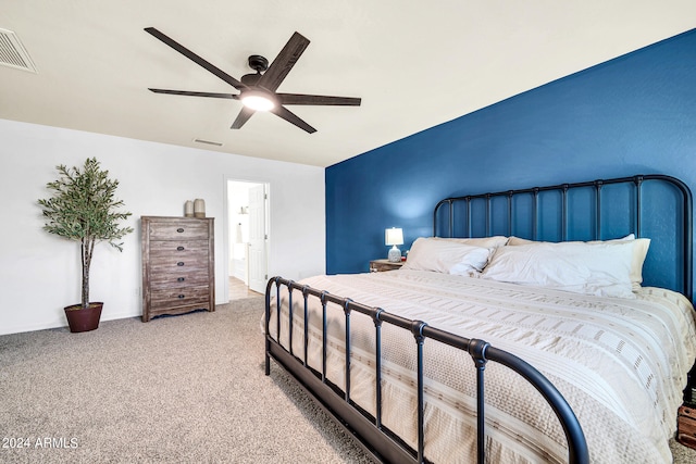 bedroom featuring light colored carpet, connected bathroom, and ceiling fan