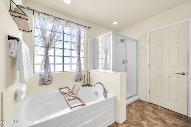 bathroom with separate shower and tub and tile patterned floors