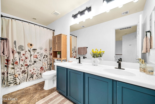 bathroom featuring dual vanity, tile patterned floors, and toilet