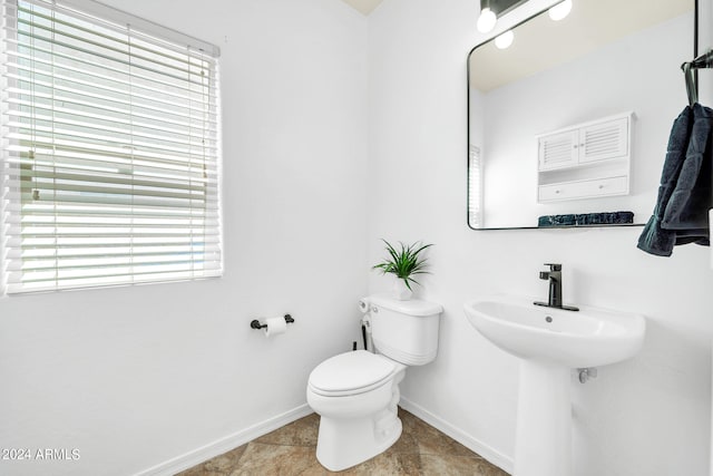 bathroom featuring tile patterned flooring and toilet