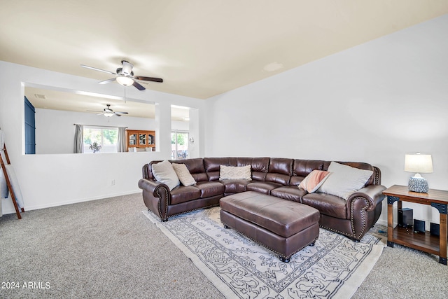 living room featuring light colored carpet and ceiling fan