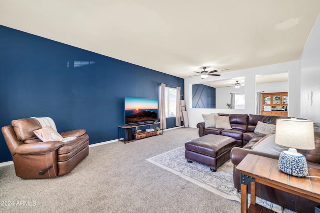 carpeted living room with ceiling fan