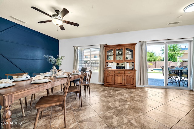 tiled dining area featuring a healthy amount of sunlight and ceiling fan