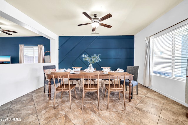 dining area with a healthy amount of sunlight, light tile patterned floors, and ceiling fan