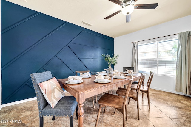 tiled dining space featuring ceiling fan