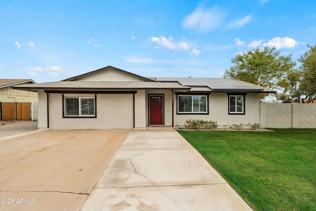 view of front of house with a front yard and solar panels