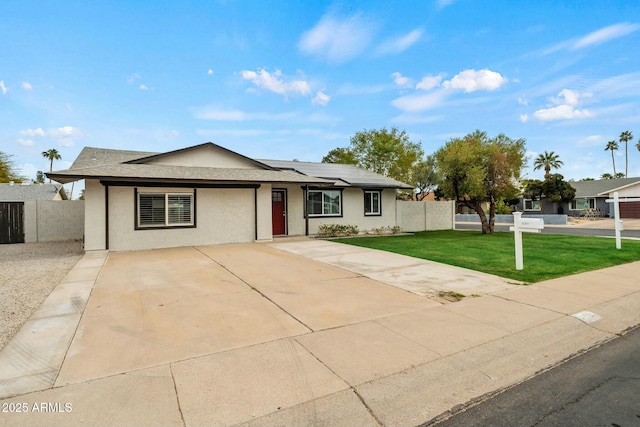 ranch-style home with a front yard and solar panels