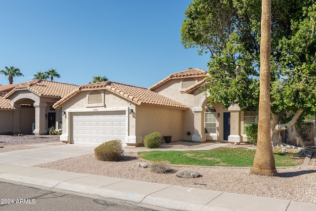 mediterranean / spanish house featuring a garage