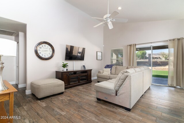 living room featuring hardwood / wood-style flooring, high vaulted ceiling, and ceiling fan