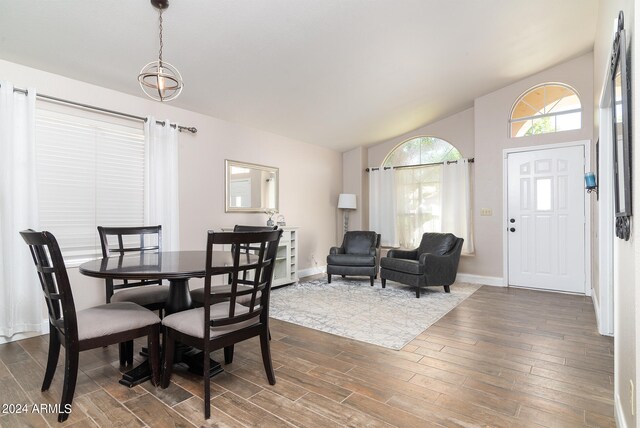 dining room with lofted ceiling and dark hardwood / wood-style flooring