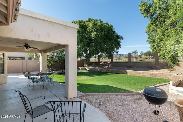 view of yard with ceiling fan and a patio area