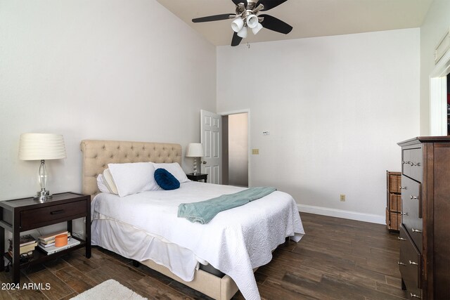 bedroom with dark hardwood / wood-style floors, vaulted ceiling, and ceiling fan