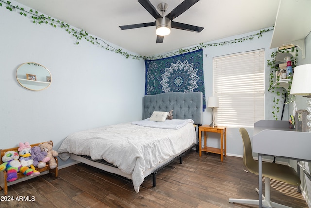 bedroom with ceiling fan and dark hardwood / wood-style floors