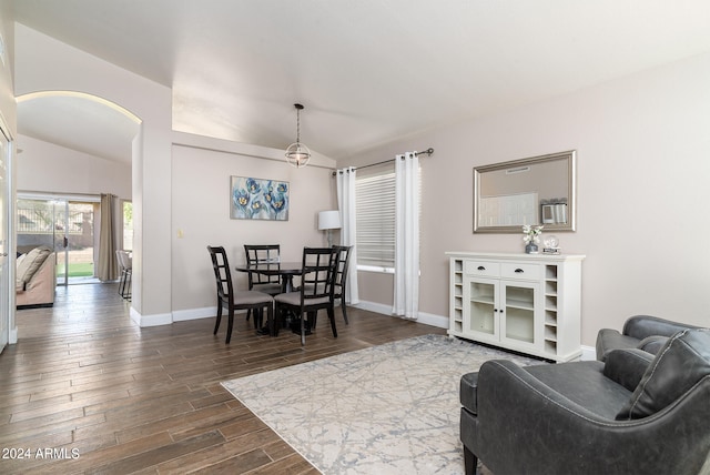 living room featuring dark hardwood / wood-style floors and vaulted ceiling