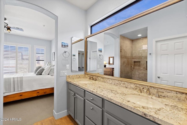 bathroom with vanity, hardwood / wood-style floors, ceiling fan, and a shower with shower door