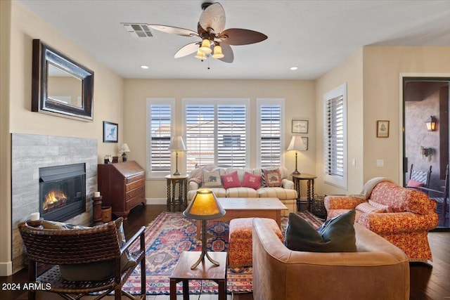 living room featuring dark wood-type flooring and ceiling fan