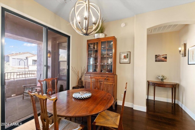 dining area featuring hardwood / wood-style floors and a chandelier