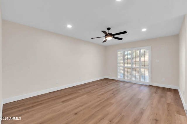 spare room featuring ceiling fan and light hardwood / wood-style floors