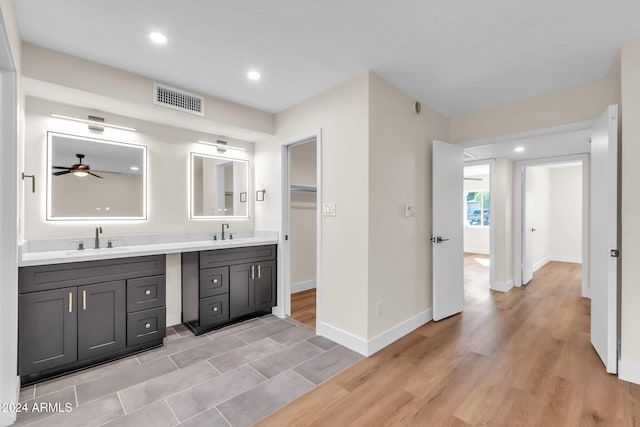 bathroom with ceiling fan, vanity, and hardwood / wood-style flooring