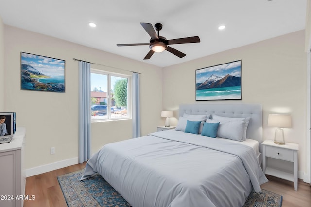 bedroom featuring ceiling fan and light hardwood / wood-style flooring