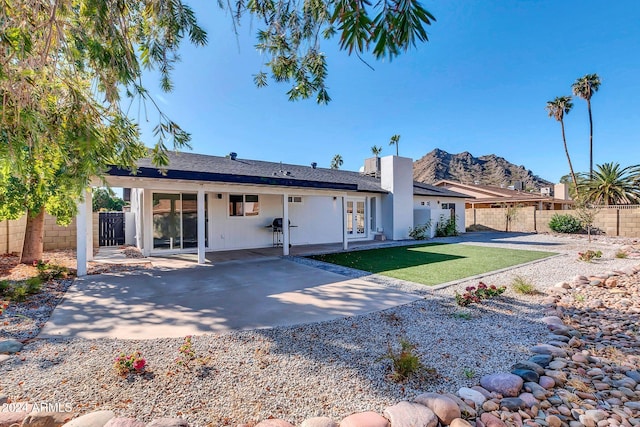 rear view of property featuring a patio and a mountain view