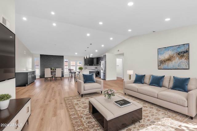 living room with lofted ceiling and light hardwood / wood-style flooring