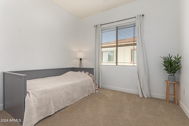 carpeted bedroom with vaulted ceiling