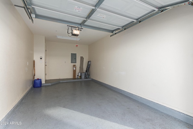 garage with a garage door opener and electric panel