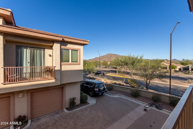 view of side of property featuring a mountain view and a balcony