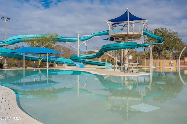 view of pool with a water slide