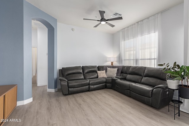 living room with ceiling fan and light hardwood / wood-style floors