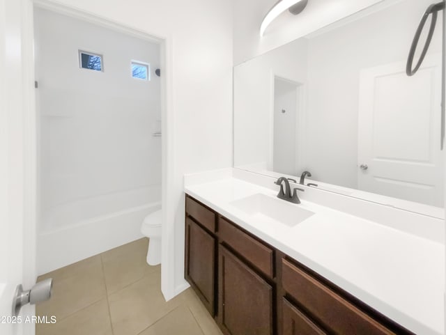 full bathroom featuring vanity, tile patterned floors, toilet, and washtub / shower combination