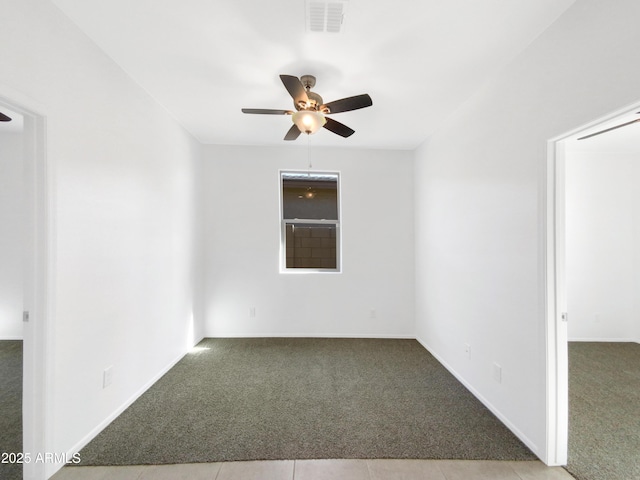 empty room with ceiling fan and light carpet