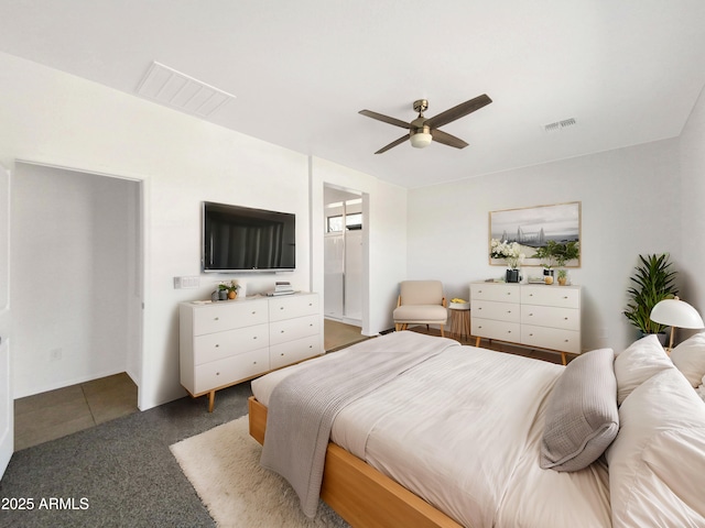 tiled bedroom with connected bathroom and ceiling fan