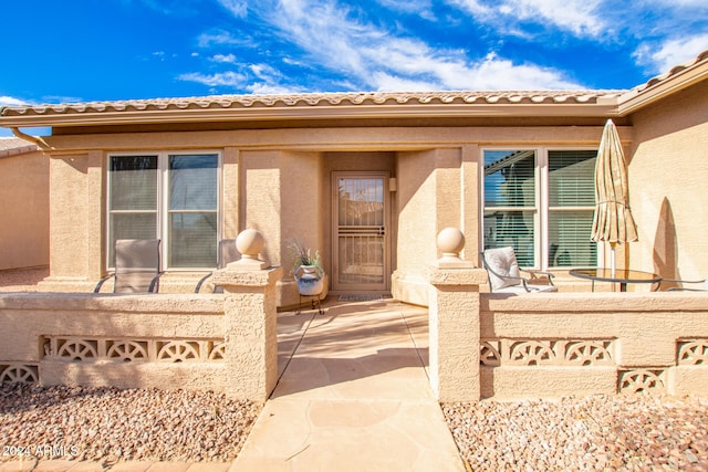 doorway to property featuring a patio