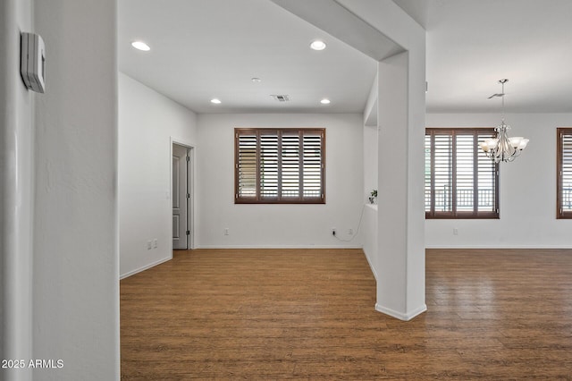 301 S 225th Ave, Buckeye, AZ 85326 - unfurnished room featuring visible vents, baseboards, an inviting chandelier, dark wood-style floors, and recessed lighting